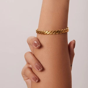 Dettaglio del bracciale a catena a corda intrecciata placcata oro 18K al polso di una donna