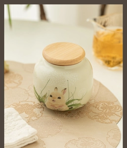 Close-up of Ru-kiln ceramic tea canister with cute rabbit pattern and bamboo lid