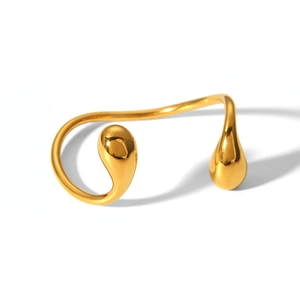 Detailed view of an 18K gold-plated asymmetrical open cuff with teardrop shaped ends