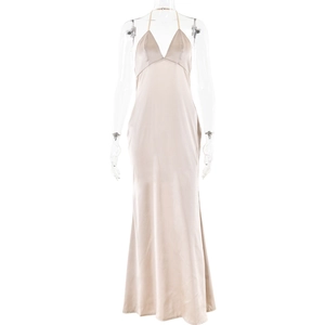 Detail of elegant beige silk-satin long dress featuring a deep V-neck and open back design