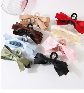 Collection of large ribbon bow hair claws in eight elegant satin colors for women
