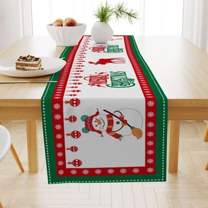 Linen Christmas table runner with snowman and reindeer patterns on a wooden dining table