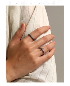 Close-up of S925 silver rings with blue diamonds and cross element on a model's hand