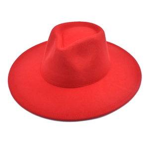 Detail of red wool felt fedora showing wide brim stitching and teardrop crown