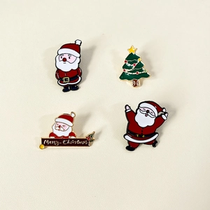 Set of four Christmas enamel pins including Santa Claus and Xmas tree badges