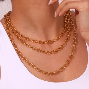 Detailed view of triple-layered 18K gold-plated stainless steel oval link chain on model