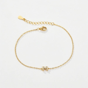 Detail of 925 silver golden bracelet with zircon-studded letter M and S925 hallmark