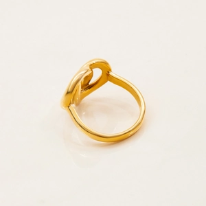 Macro detail of 18K gold stainless steel heart knot ring with high polish finish