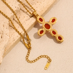 Detail of 18K gold cross pendant with amber gemstones and twisted rope chain necklace