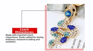 Detailed view of snake keychain with sparkling blue and clear rhinestones on gold alloy base