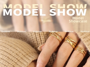 Three-piece gold titanium steel ring set in layered minimalist design shown on hand