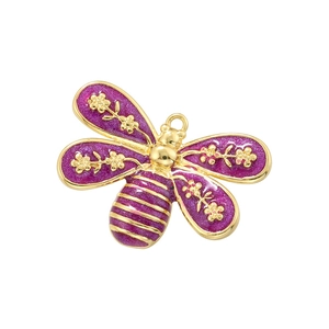 Detail of purple enamel butterfly pendant with gold floral patterns and glitter finish