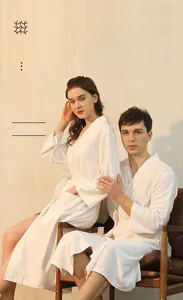 Detail view of white waffle weave fabric showing breathable texture for hotel bathrobes