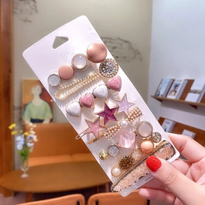 Detail of candy color hair clip set featuring pearls and rhinestones on a card
