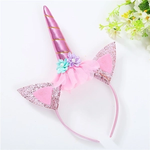 Detail of pink unicorn headband with glitter ears, spiral horn and colorful mesh flowers