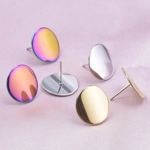 Macro shot of flat disc stud earring bases in gold, silver, and iridescent rainbow finish