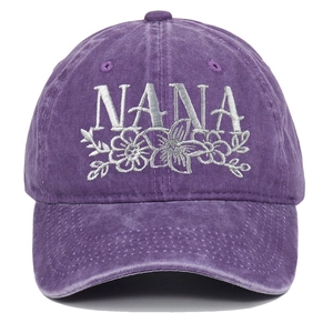 Close-up of purple washed cotton baseball cap with NANA floral embroidery detailing