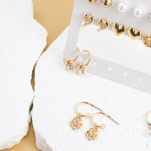 9-pair gold earring set featuring pearl hearts, floral charms and crystal hoop designs