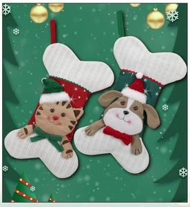 Detail of Christmas pet stockings with 3D cat and dog motifs on festive green background