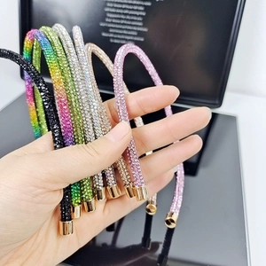 Detailed view of colorful rhinestone headbands with various sparkling crystals