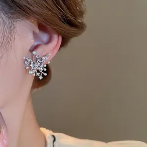 Elegant snowflake earrings with zircon and pearls on model for a premium jewelry look