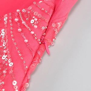Close-up of pink dress showing intricate sequin beadwork and matching invisible zipper