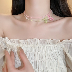 Detail of double-layer beaded choker featuring handmade flower design and imitation pearls