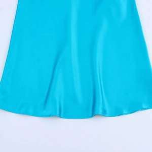 Detail of smooth blue satin fabric showing elegant draped texture and glossy finish