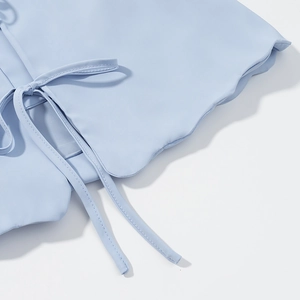Light blue three-piece set with tie-front detail and wavy edges in a smooth woven fabric