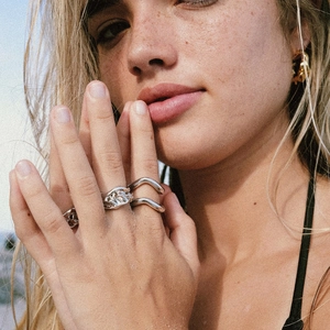 Irregular lava texture ring and minimalist wave design on a model at beach