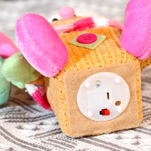 Detail view of the plush toy base showing the ON/OFF switch and battery compartment