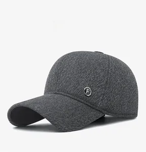 Close-up of thick grey wool baseball cap with round metal F logo and knit texture