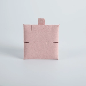 Close-up of pink suede jewelry display card with hanging loop and necklace slots