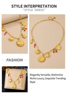 Detail of vintage gold necklace with sun, starfish, red chili, and cross charms