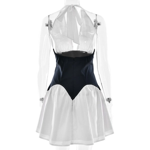 Detail showing back view of backless halter dress with black and white color block design