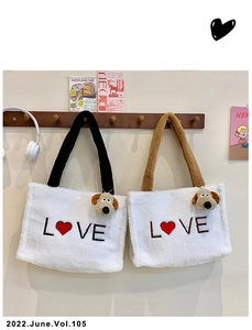 Detail of plush tote bag with LOVE embroidery and cute dog charm hanging on a wooden hook