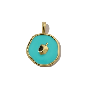 Macro view of blue enamel pendant with gold-plated Dreidel charm on white backdrop