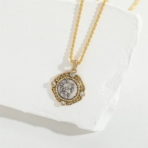 Vintage gold twist chain necklace with a silver coin pendant and zircon accents