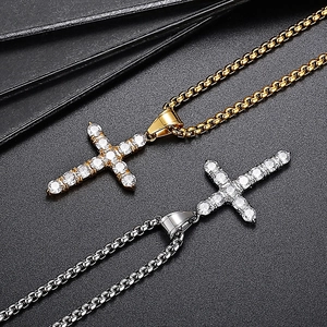 Close-up of hip hop cross pendants in gold and silver finish with micro-pave zircons
