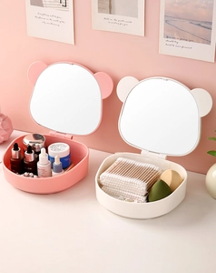 Detail of pink and beige panda-eared makeup storage boxes with built-in mirrors