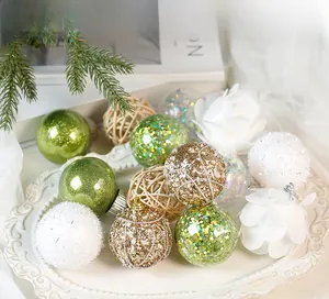 Detailed view of mixed Christmas ornaments in a ceramic tray for festive decoration