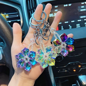 Detailed view of colorful crystal snowflake car keychains with metal lobster clasps