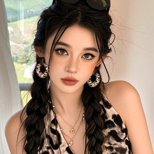 Stylish model wearing large leopard print hoop earrings and a matching halter neck top
