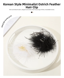 Detail of fluffy black and white ostrich feather hair claws on a decorative white tray