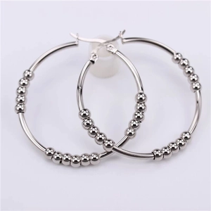Minimalist silver stainless steel hoop earrings with movable beads on white background
