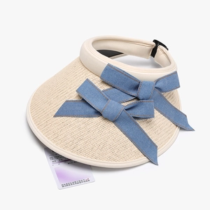 Foldable beige straw sun hat for women with denim blue bow and UV protection sensor card