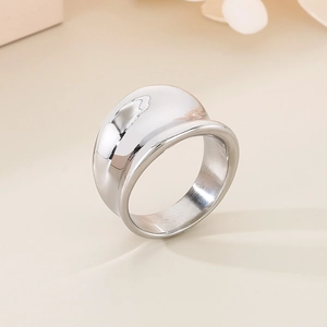 Macro shot of silver chunky dome ring with a polished mirror finish on a cream background