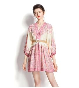 Detailed view of pink bohemian print mini dress with V-neckline and lantern sleeves