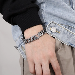 Close-up of vintage stainless steel chain bracelet with embossed tiger pattern clasp
