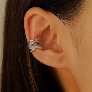 Macro detail of silver double-layered X-cross ear cuff with shimmering zircon pavé inlay